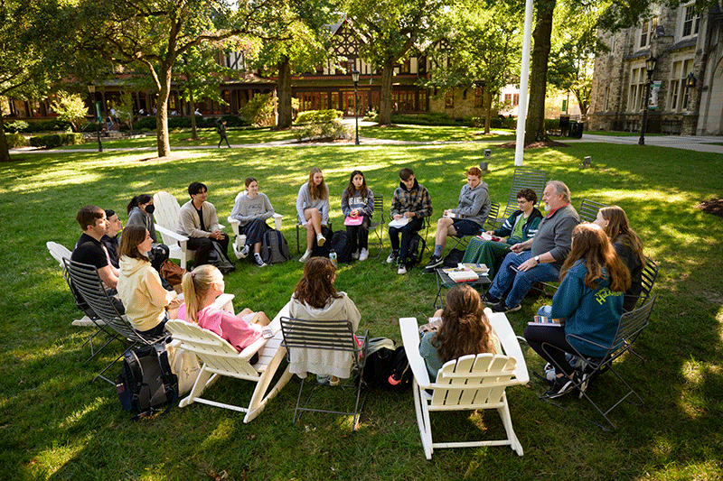 Joe Walsh, Ph.D., professor of History and Classics, teaches an outdoor class on Loyola's Quad.