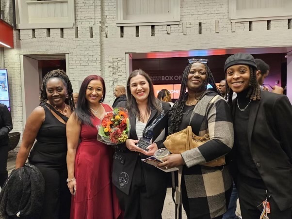 Marina Fazio, '19 (center), smiles after receiving the Beacon of Light Award from the Baltimore Teacher Network on Oct. 25.