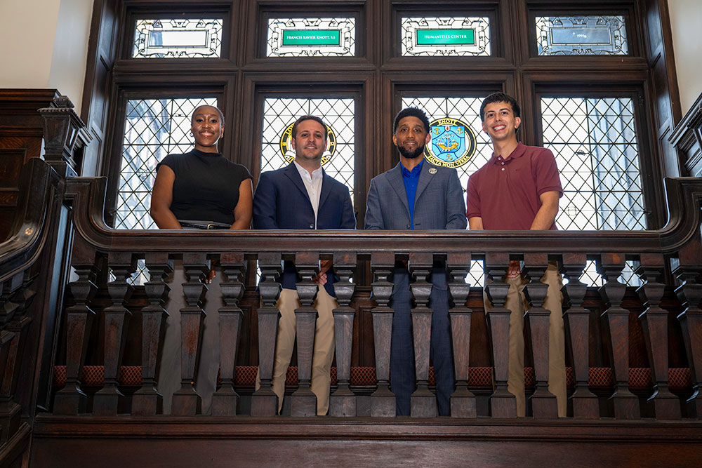 Ifeoma Ezeani, ’26, Braeden DiFranceisco, ’26, Baltimore Mayor Brandon Scott, and Gabriel Gómez, ’26, on the stairs of the Humanities Center (JJ McQueen, chief photographer, Baltimore City Mayor’s Office)