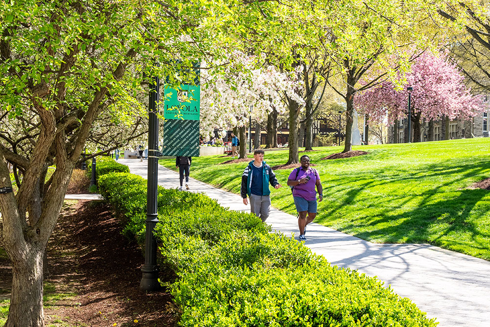 Students walk across Loyola's Evergreen campus in April 2026