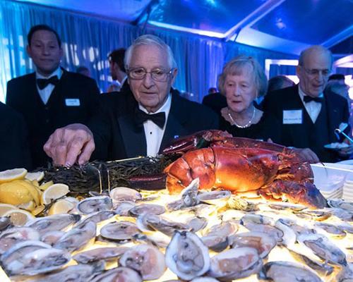 Event attendees in front of an oyster display