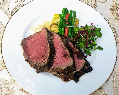 Carved tenderloin plated with vegetables