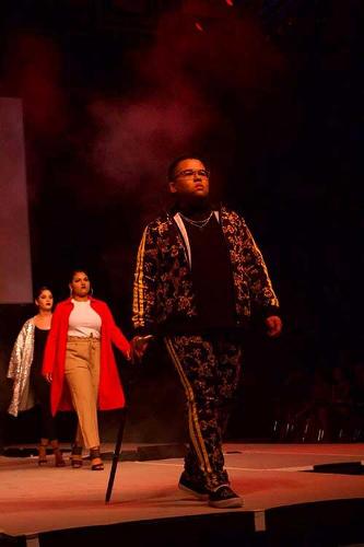 Models walking in a line down the catwalk.