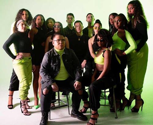 Student models posing in black and lime green outfits against a green backlight.