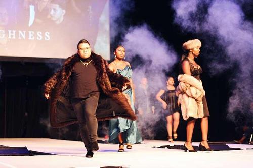 Student models walking in various directions on the catwalk while smoke hangs in the air.