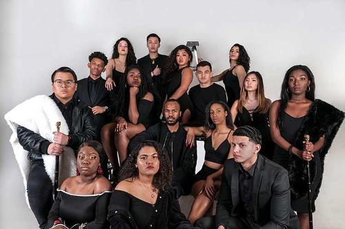 The entire 2019 model cast in various poses, dressed in black formal attire.